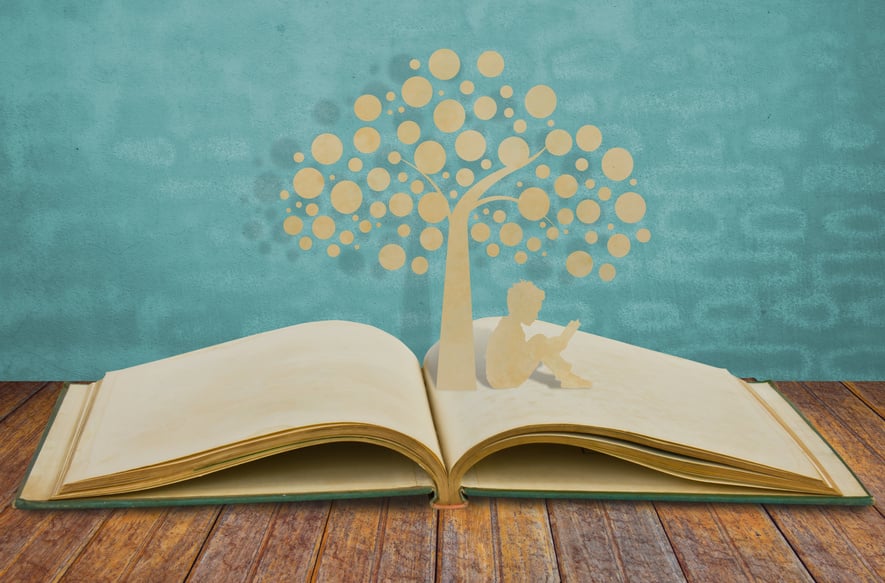 Paper cut of children read a book under tree